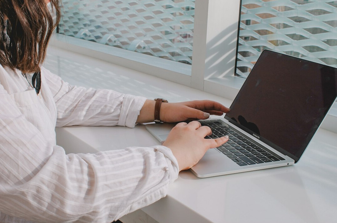 programmer typing on laptop
