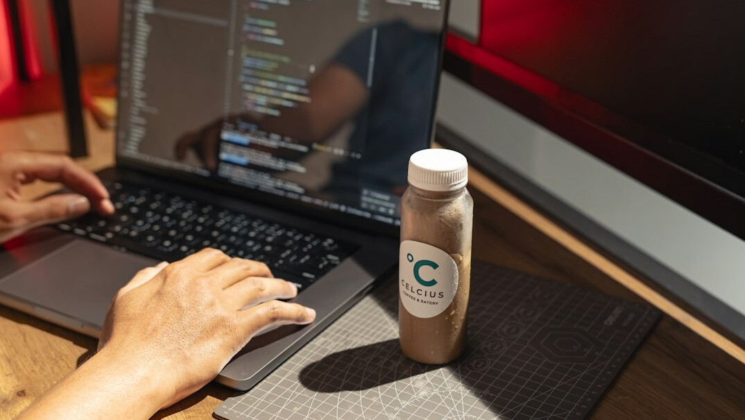 programmer coding on laptop