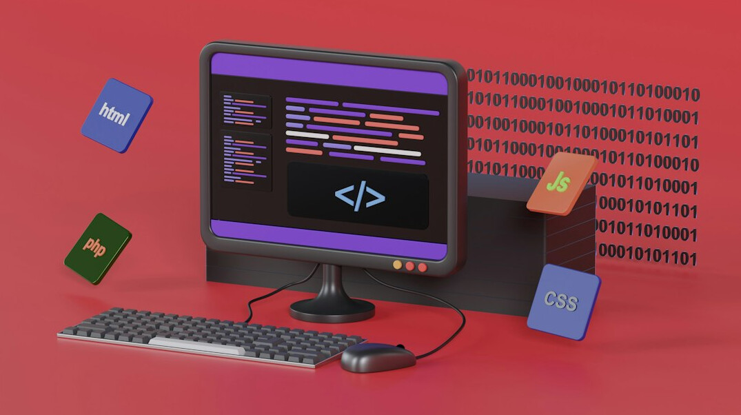 programmer at desk with multiple monitors